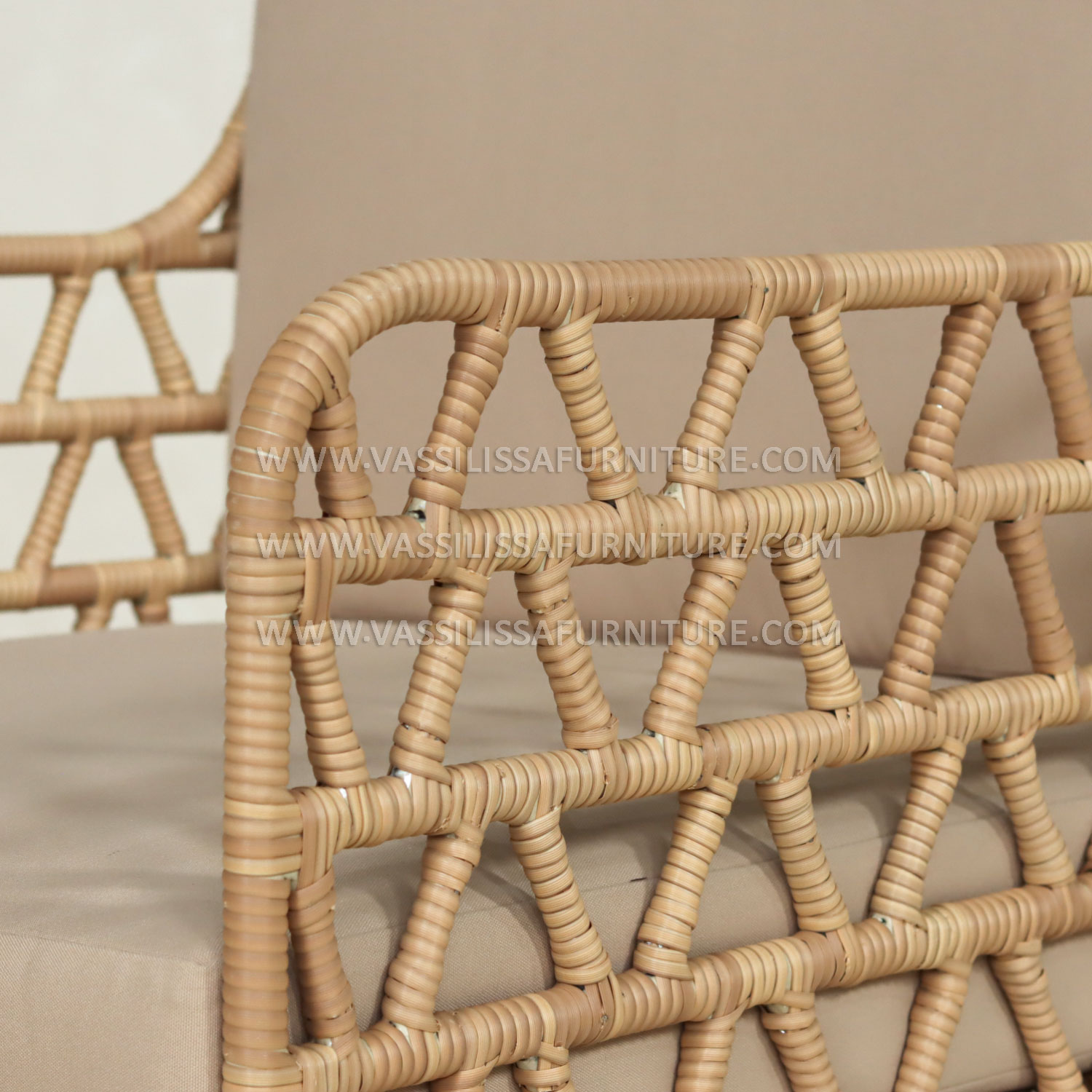 Japandi-style indoor rattan armchair with teak wood frame and beige cushions