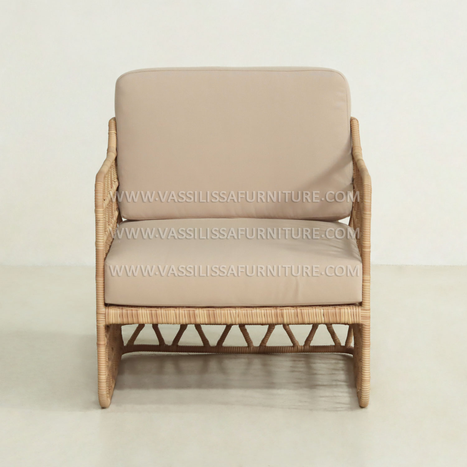 Japandi-style indoor rattan armchair with teak wood frame and beige cushions