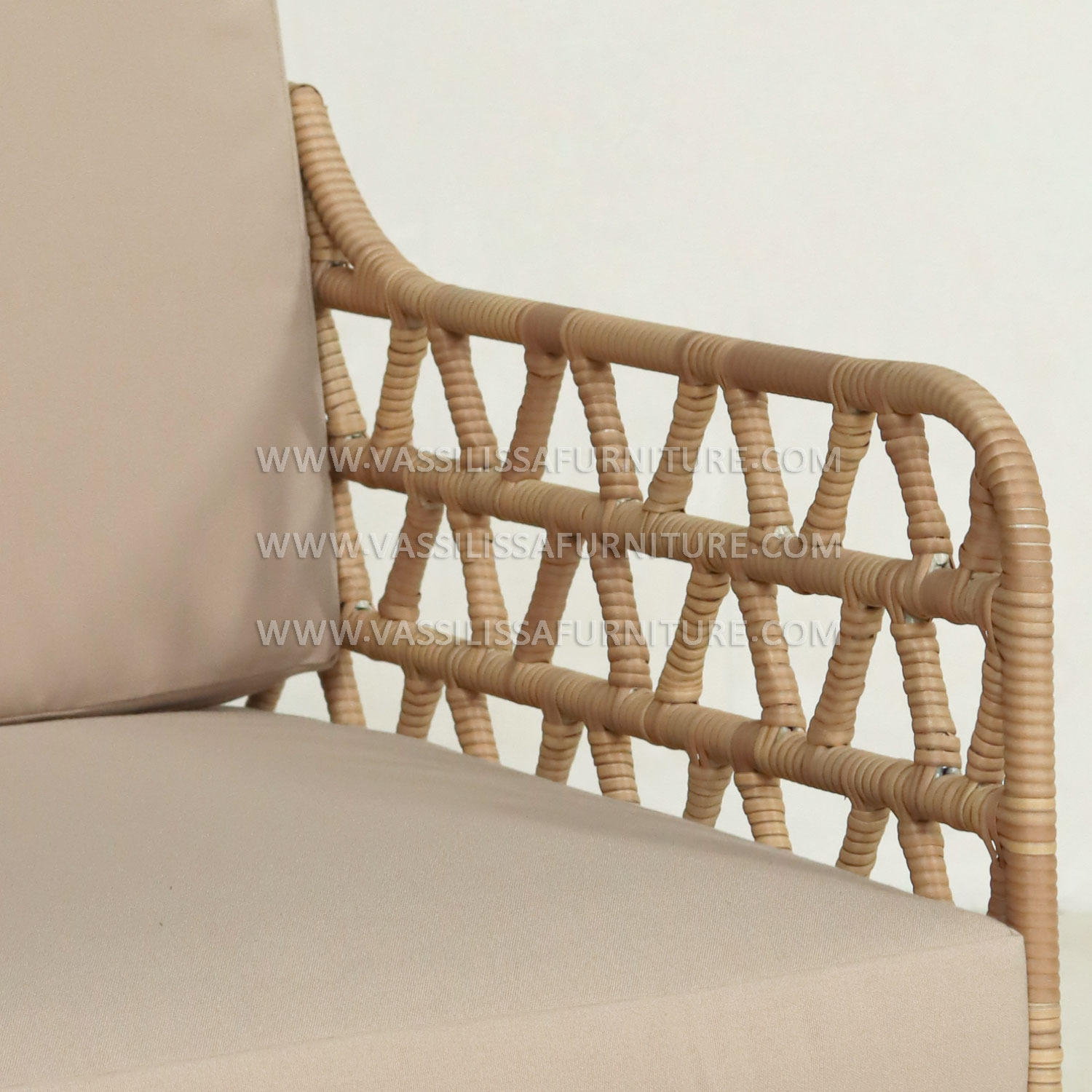 Japandi-style indoor rattan armchair with teak wood frame and beige cushions
